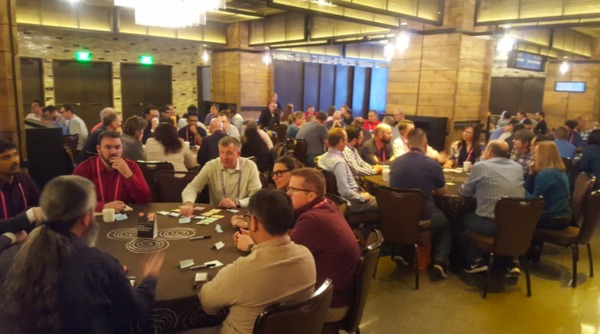 Group of people at a conference sitting at round tables.